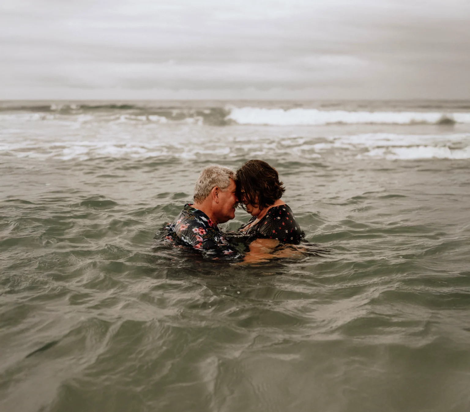 Couple delicately placed in water, reflecting natural light, symbolizing love and commitment