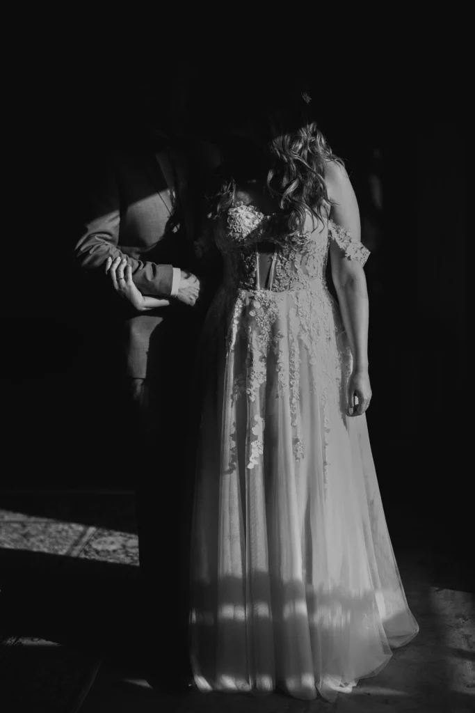 A cinematic shot of a bride and groom bathed in soft light, capturing a moment of pure love and elegance