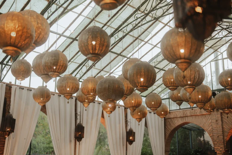 Elegant Moroccan lanterns hanging from a glass ceiling.