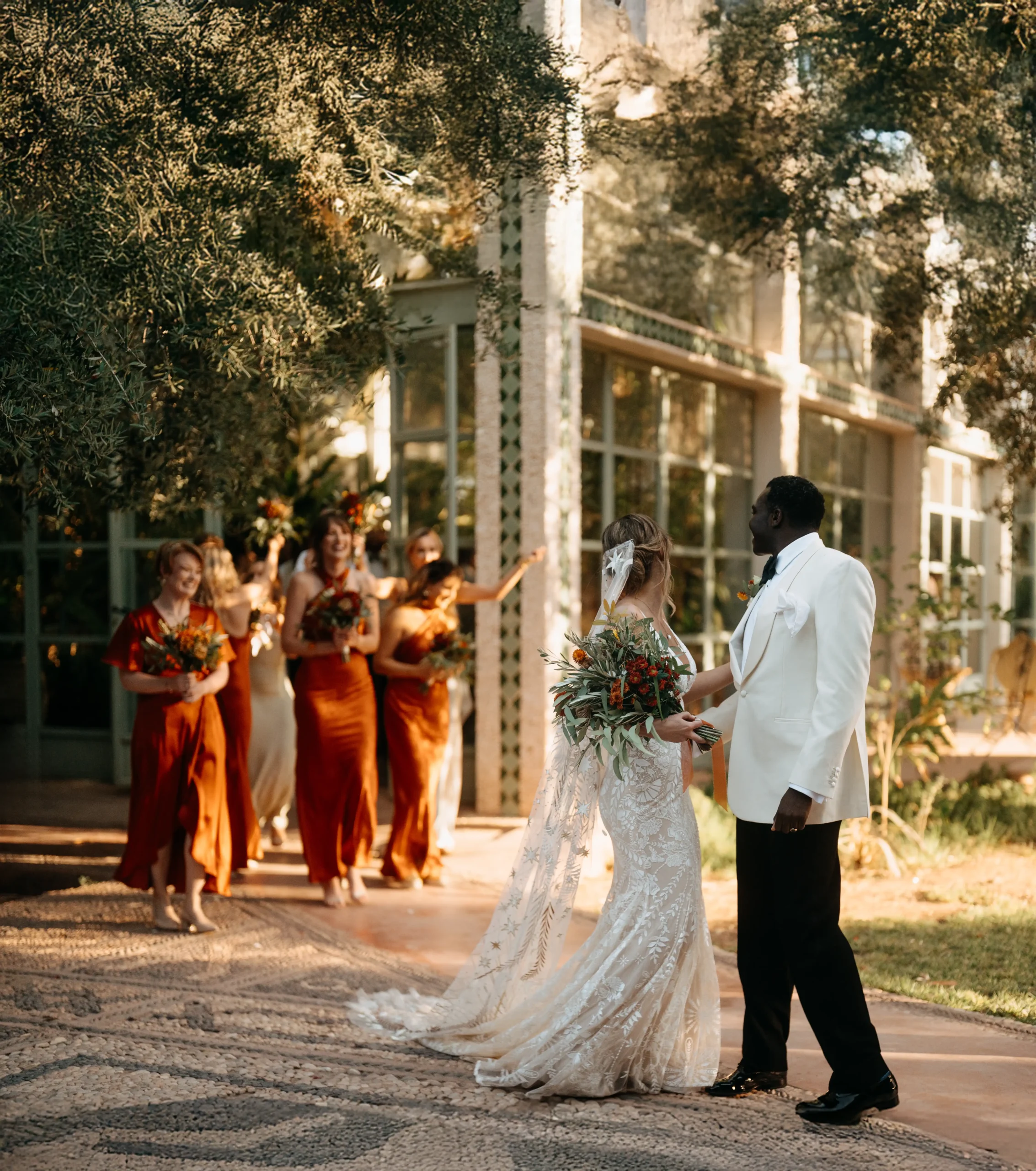 Bride putting on her wedding shoes, a peaceful moment of anticipation before the big day Bride and groom in front of a Mediterranean wedding venue, surrounded by cheering bridesmaids.