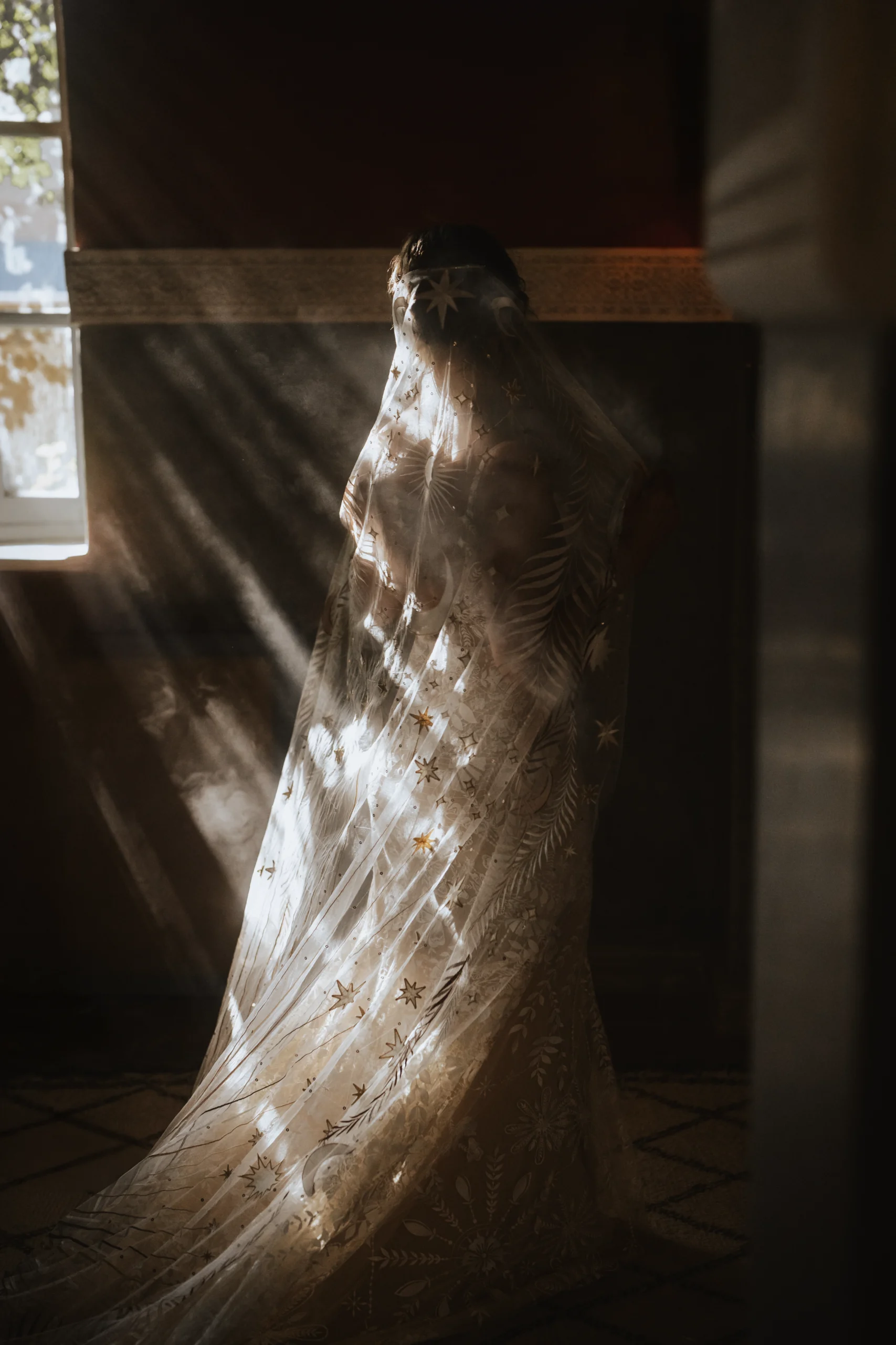 Bride laughing with bridesmaids as she puts on her wedding dress, capturing a moment of joy and excitement Destination Wedding Morocco Cinematic captured
