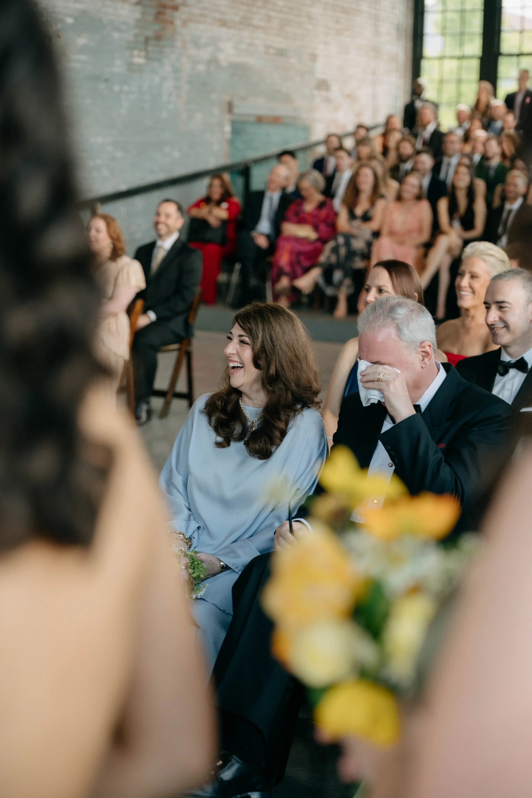 Parents reacting emotionally during the ceremony.