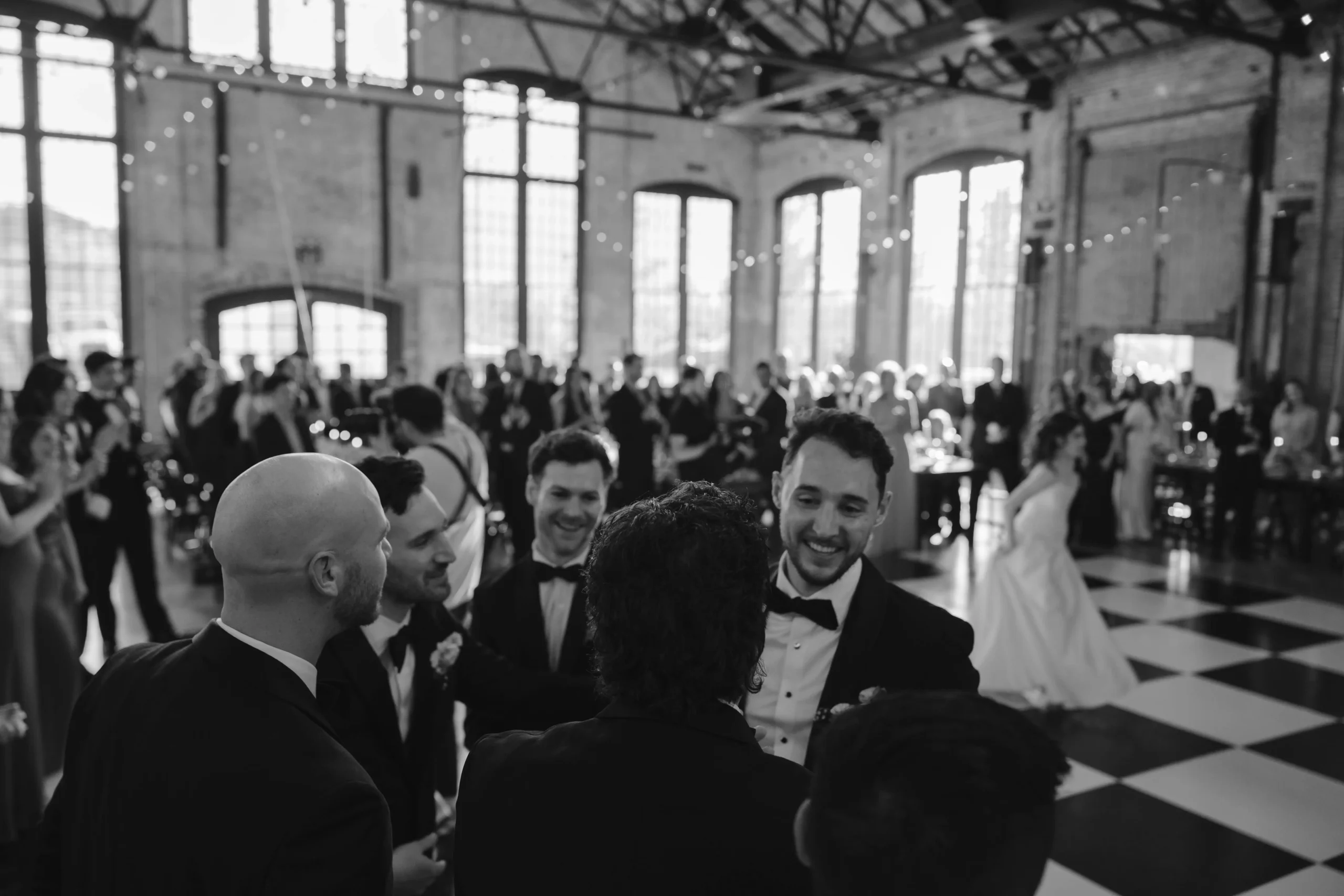 Guests enjoying the wedding reception inside the industrial-style Hudson Basilica.