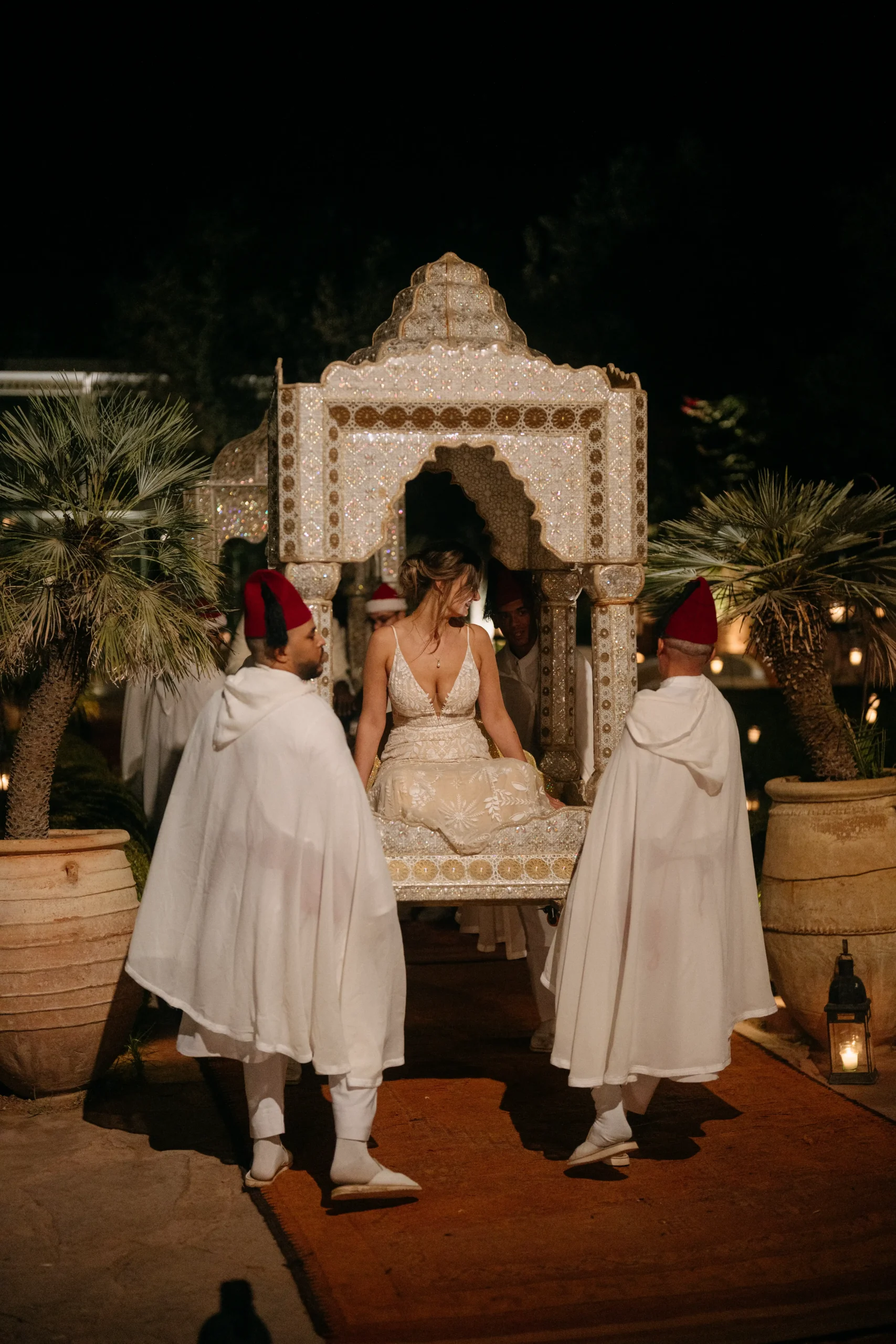 Moroccan wedding tradition – bride being carried in a golden amaria.