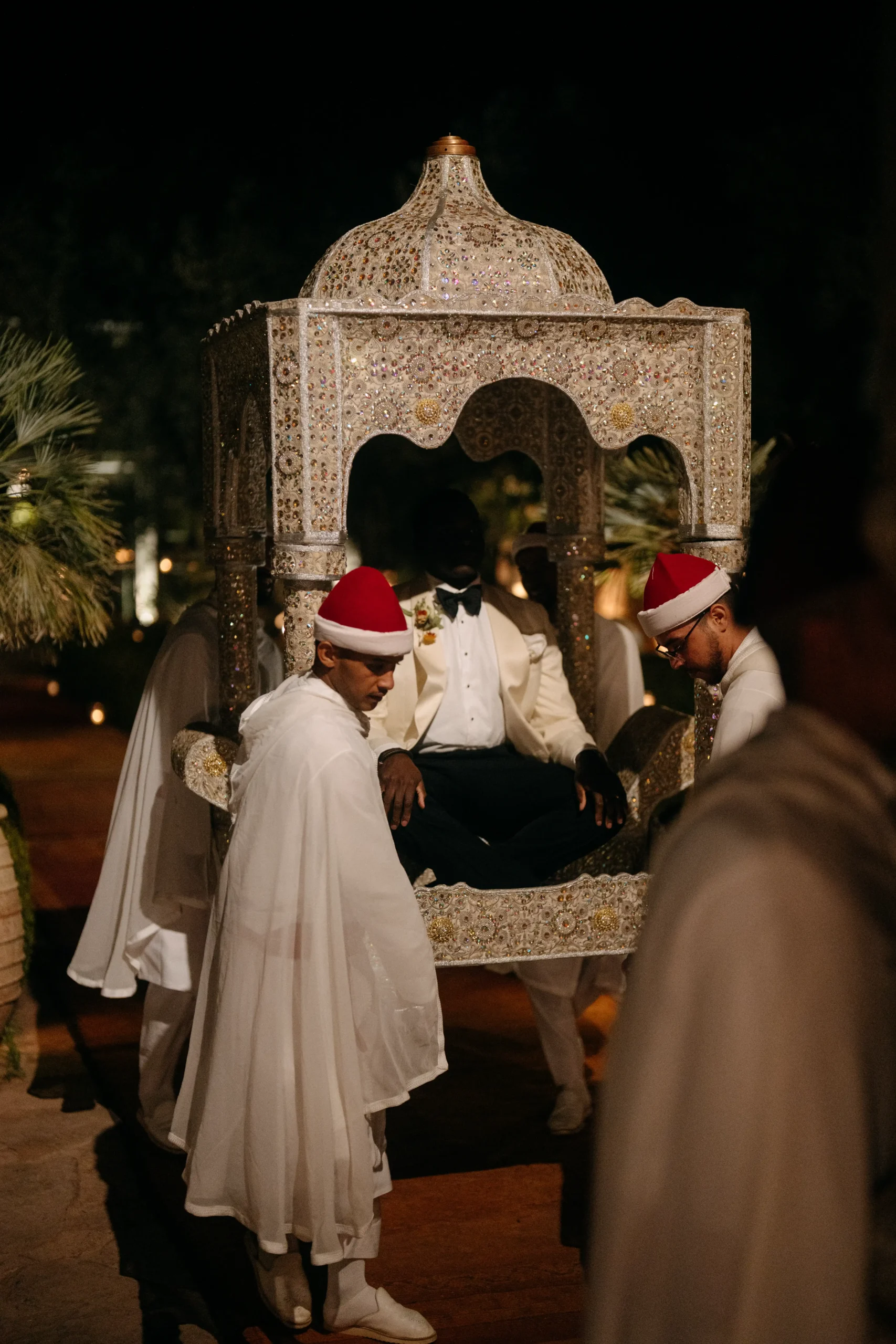 Groom carried in a traditional Moroccan amaria at night.