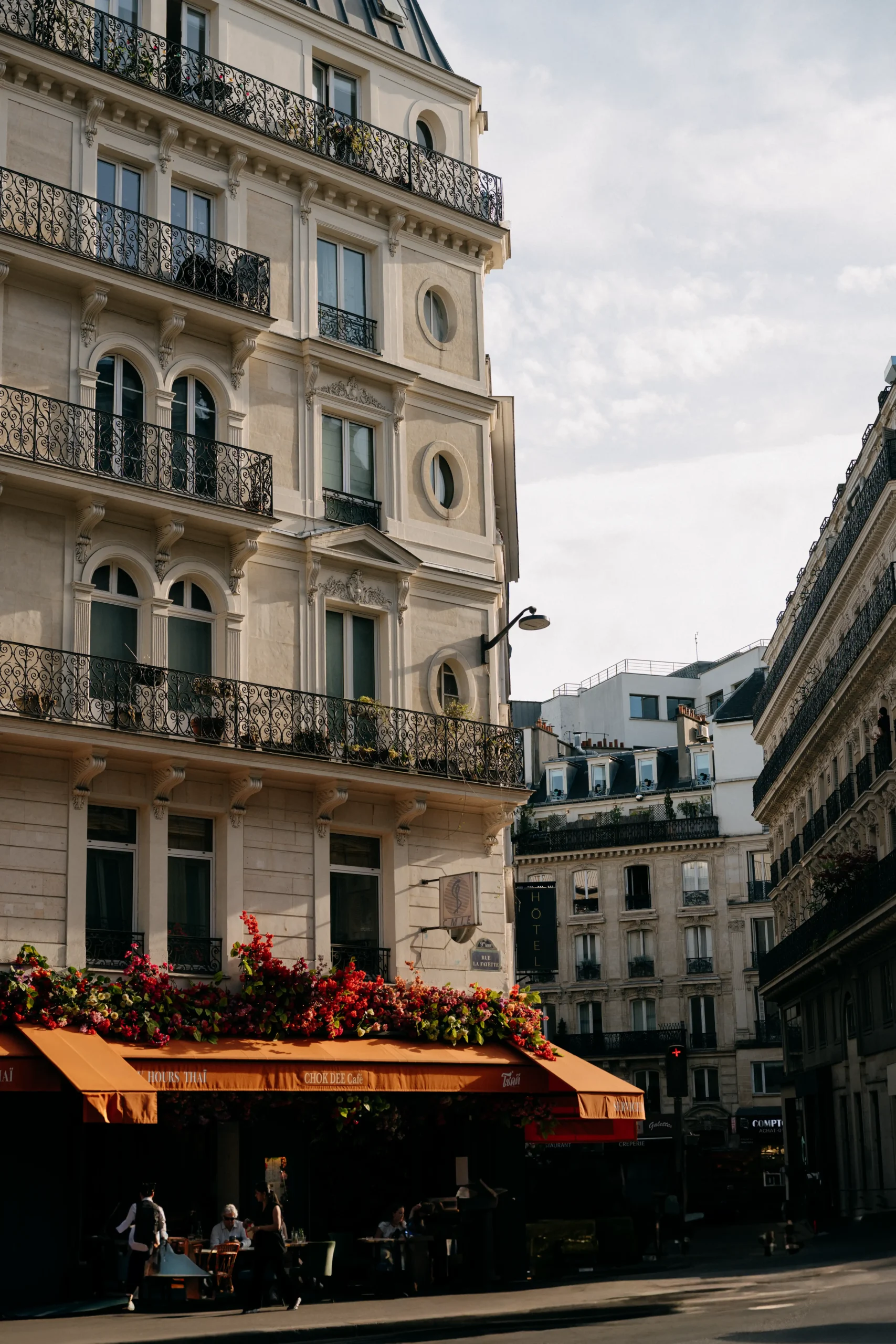 Couple sharing a kiss in the shadows of Jardin des Tuileries.