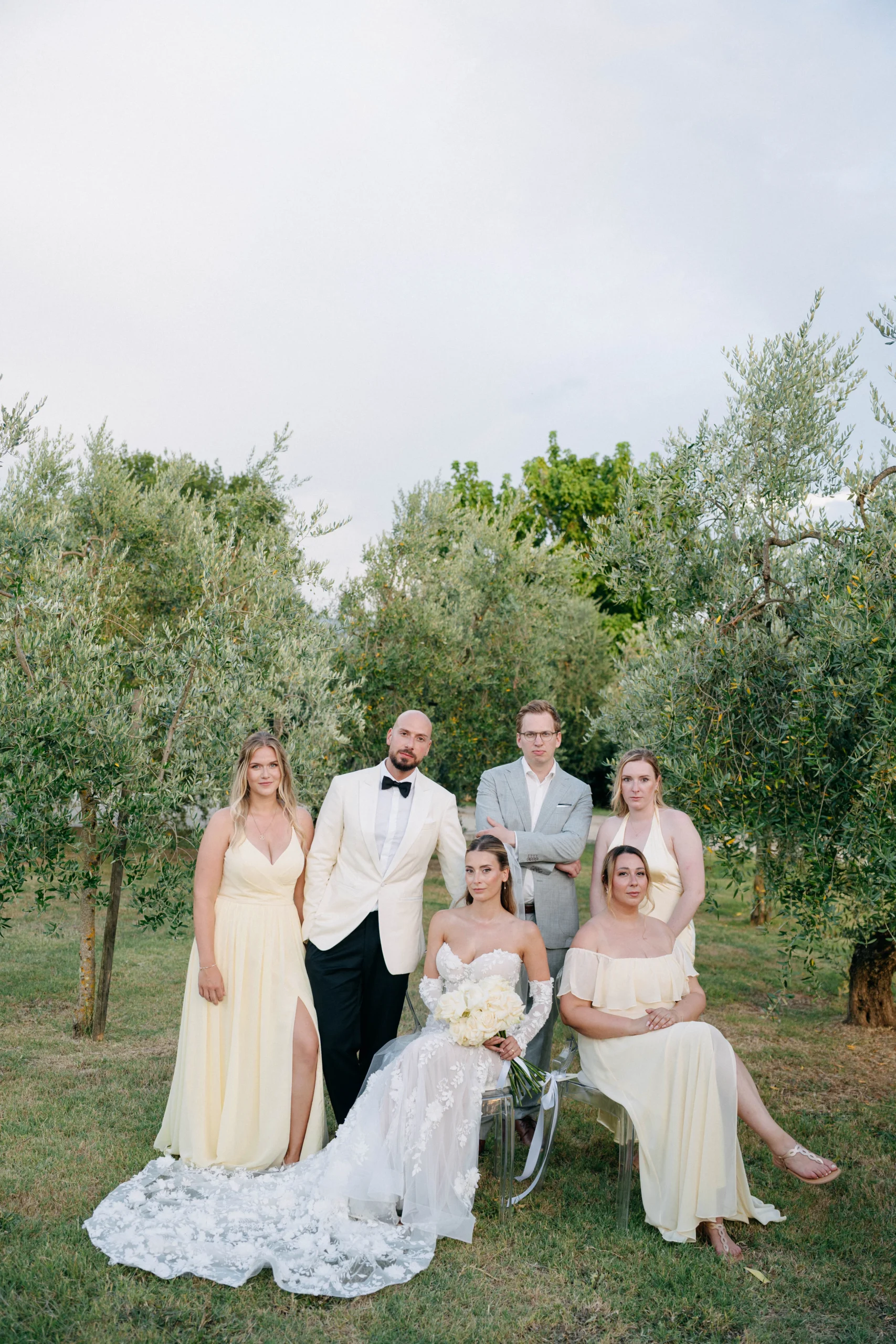 Wedding couple posing with family and friends in an olive grove