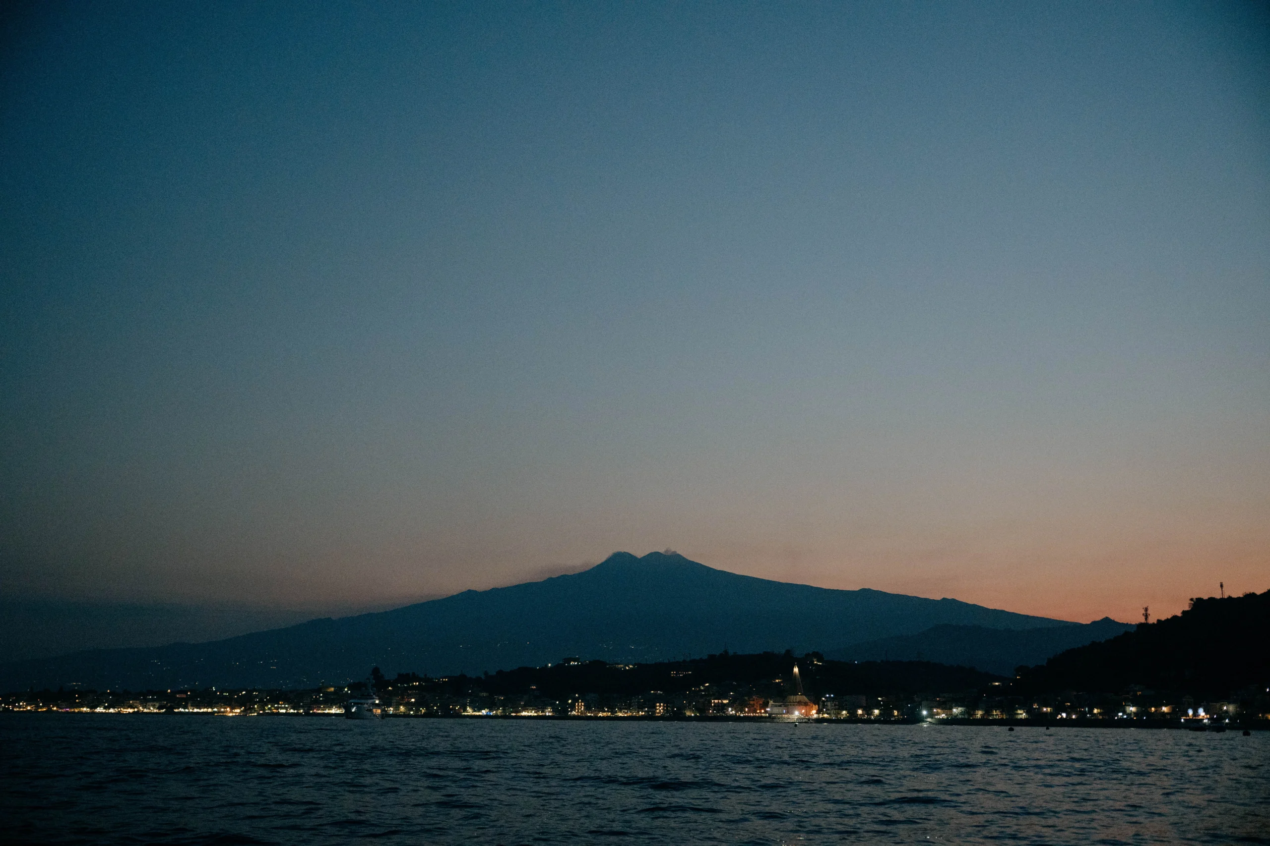 Mount Etna at sunset seen from the Sicilian coast