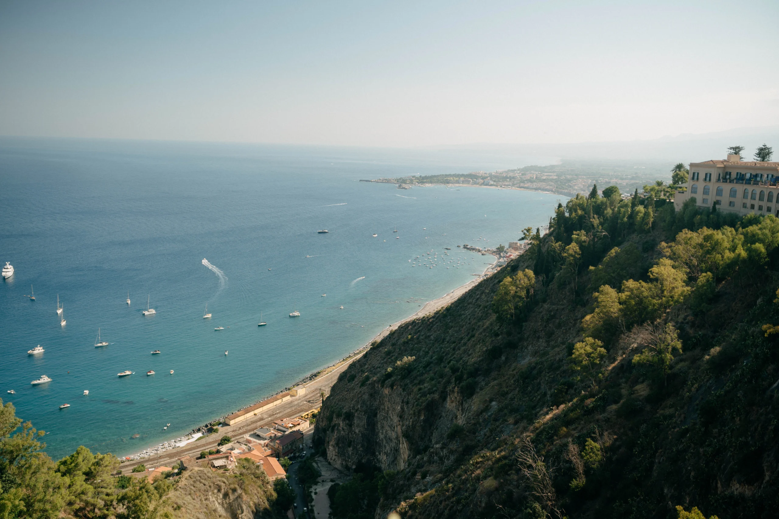 Aerial view of the Sicilian coast and boats near Castello San Marco