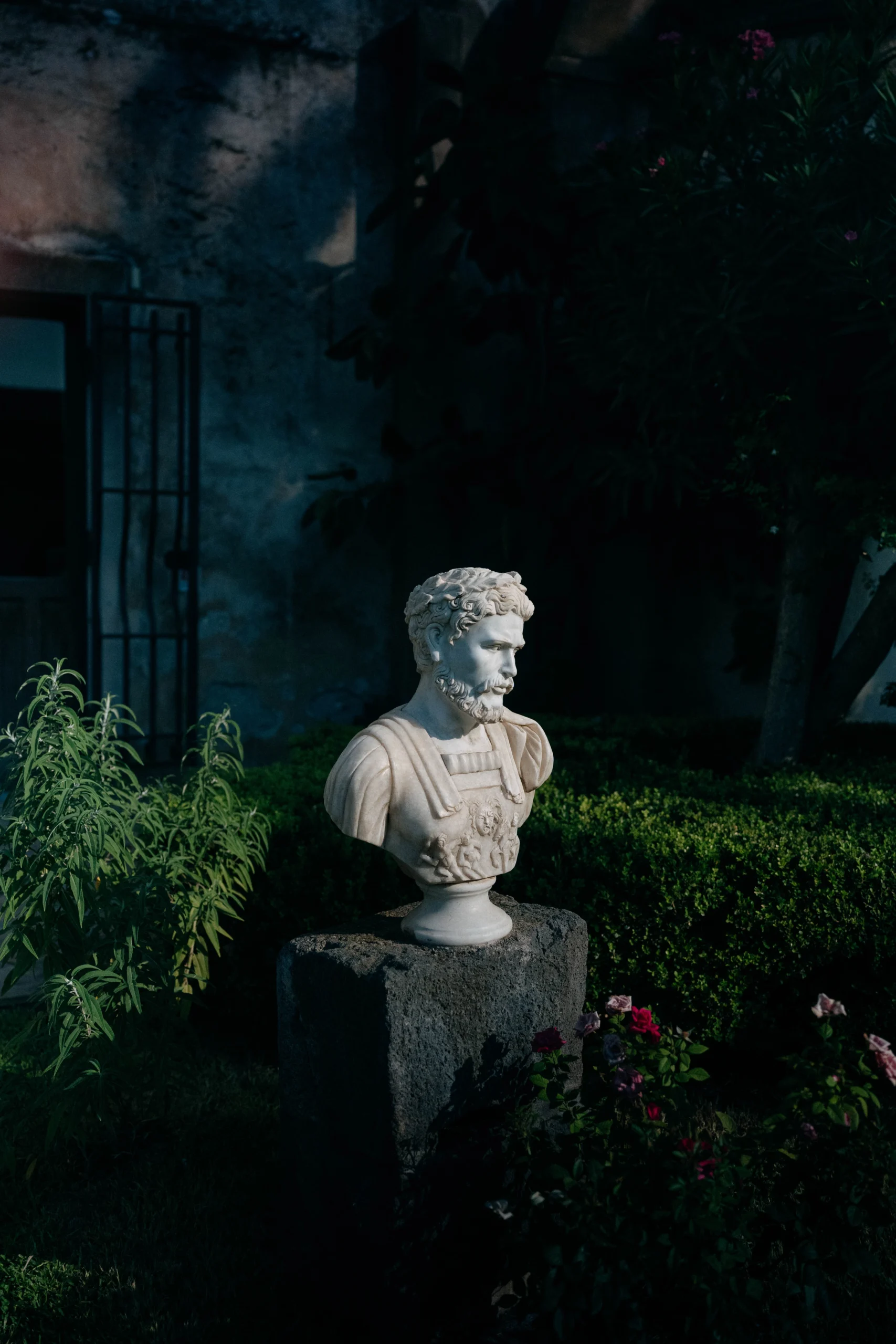 Marble statue in a Sicilian villa garden at night