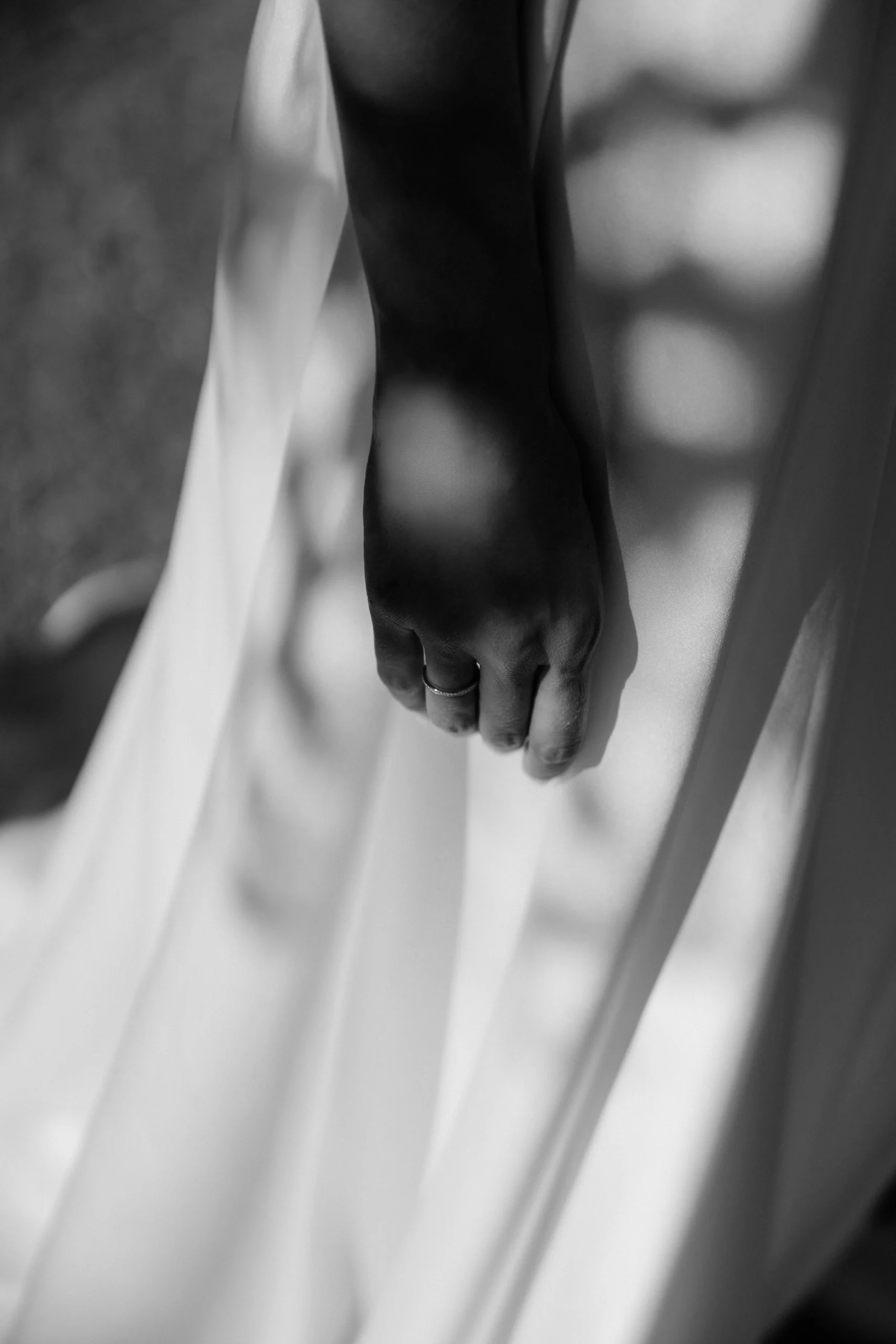 Close up of a hand on the wedding dress with shadow pattern, black and white, Munich at La Villa