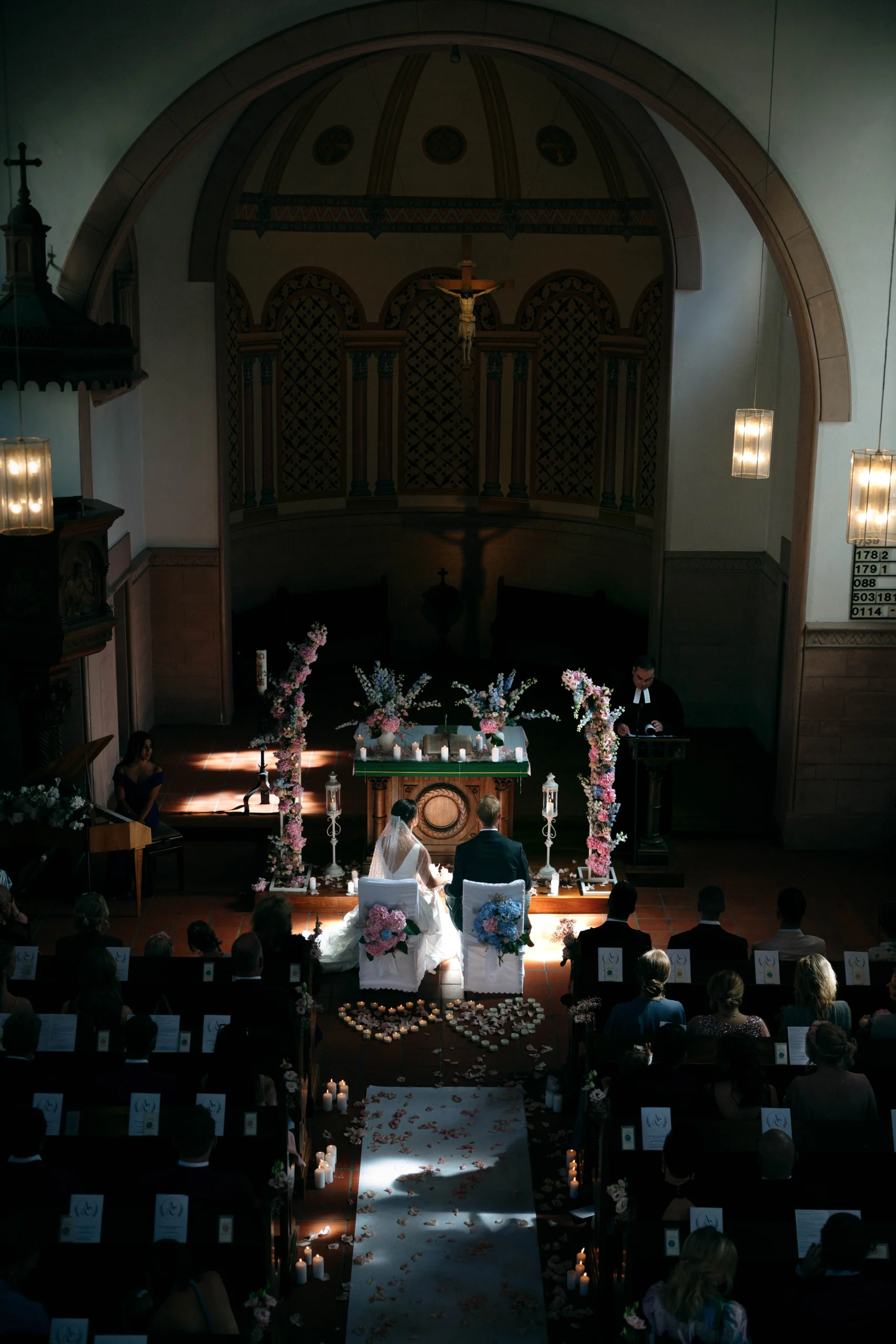 Ceremony from above inside the church, a beam of light on the couple, Munich wedding at La Villa