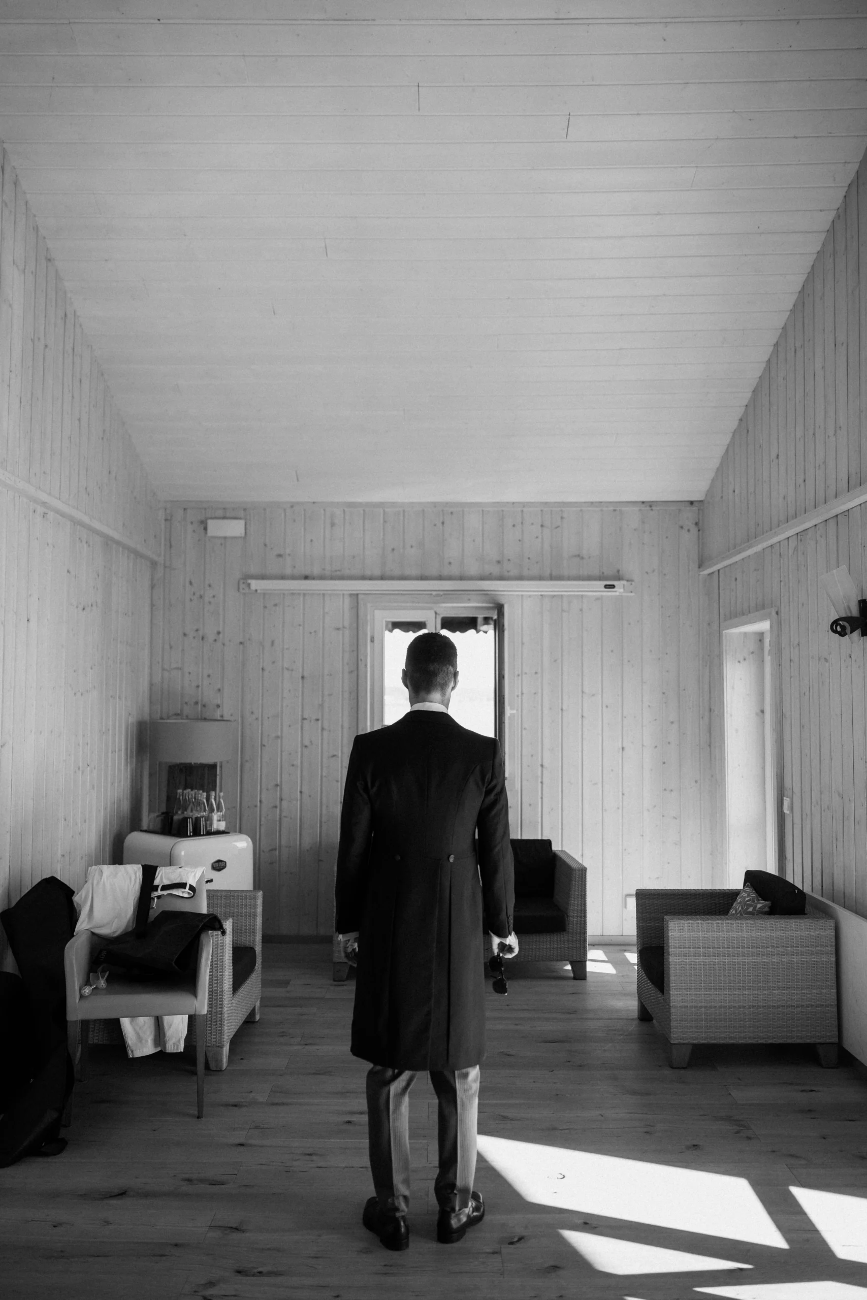 Groom in a suit in a bright room, black and white, Munich wedding at La Villa