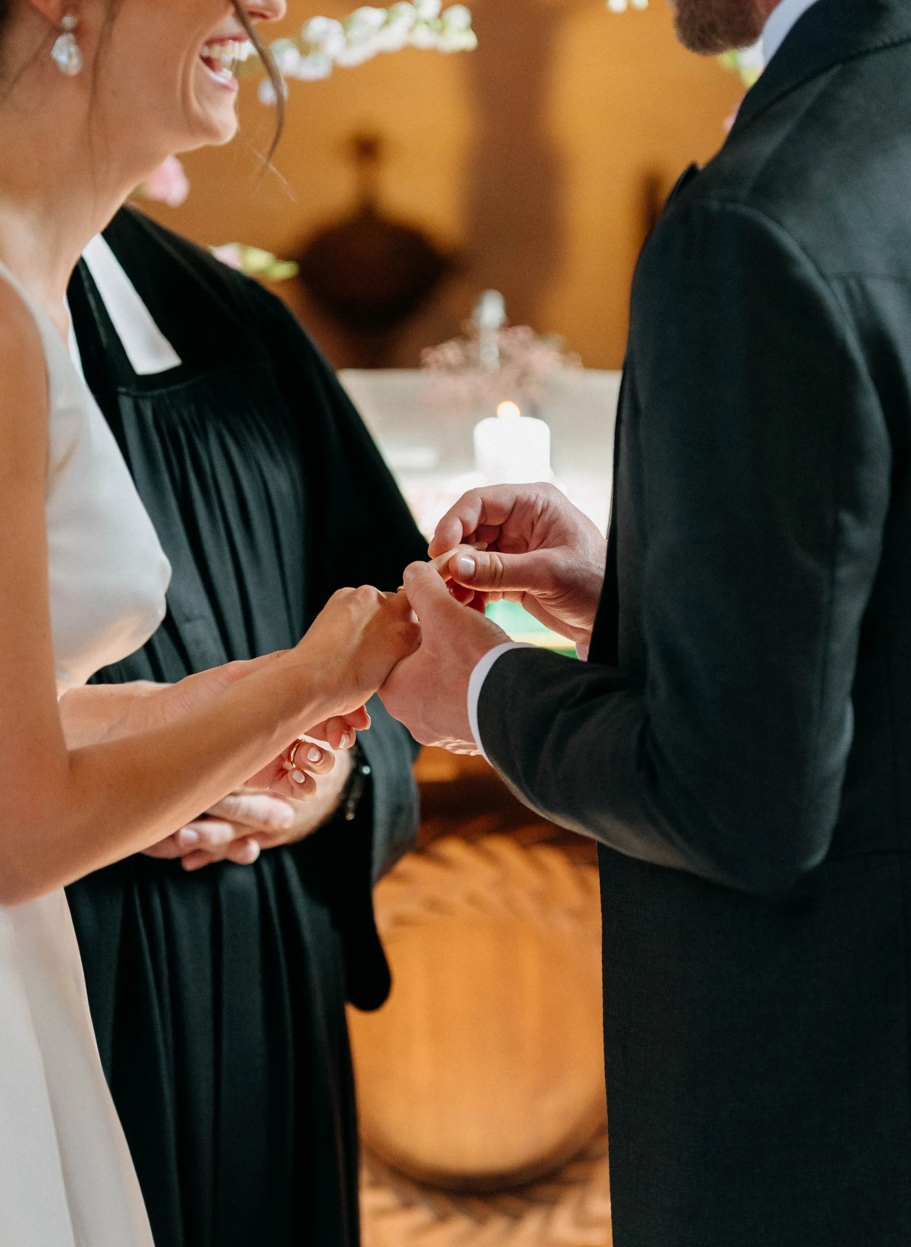 Ring exchange in the church, hands in focus, Munich wedding at La Villa