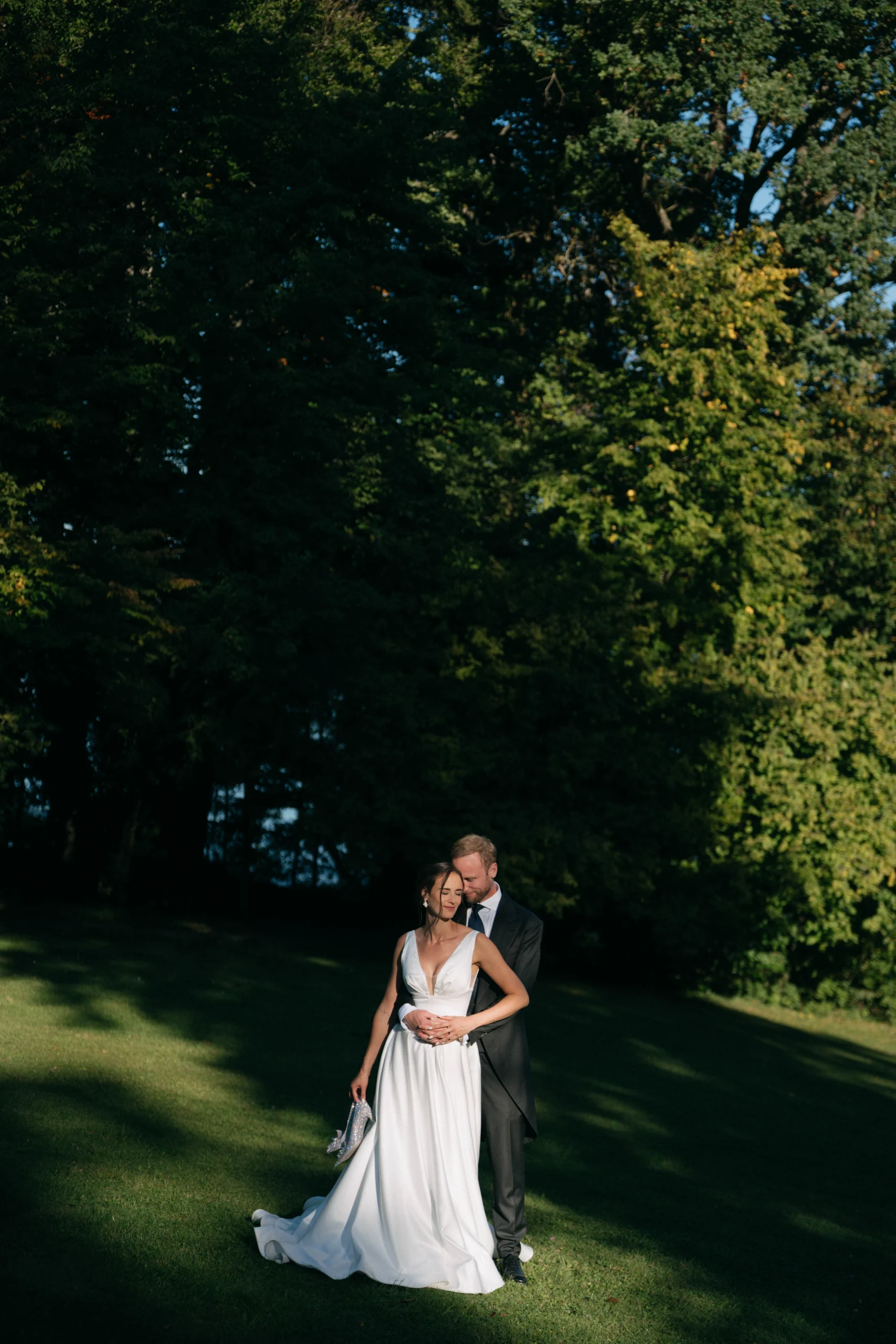 Couple embracing on a lawn in evening light, Munich wedding at La Villa