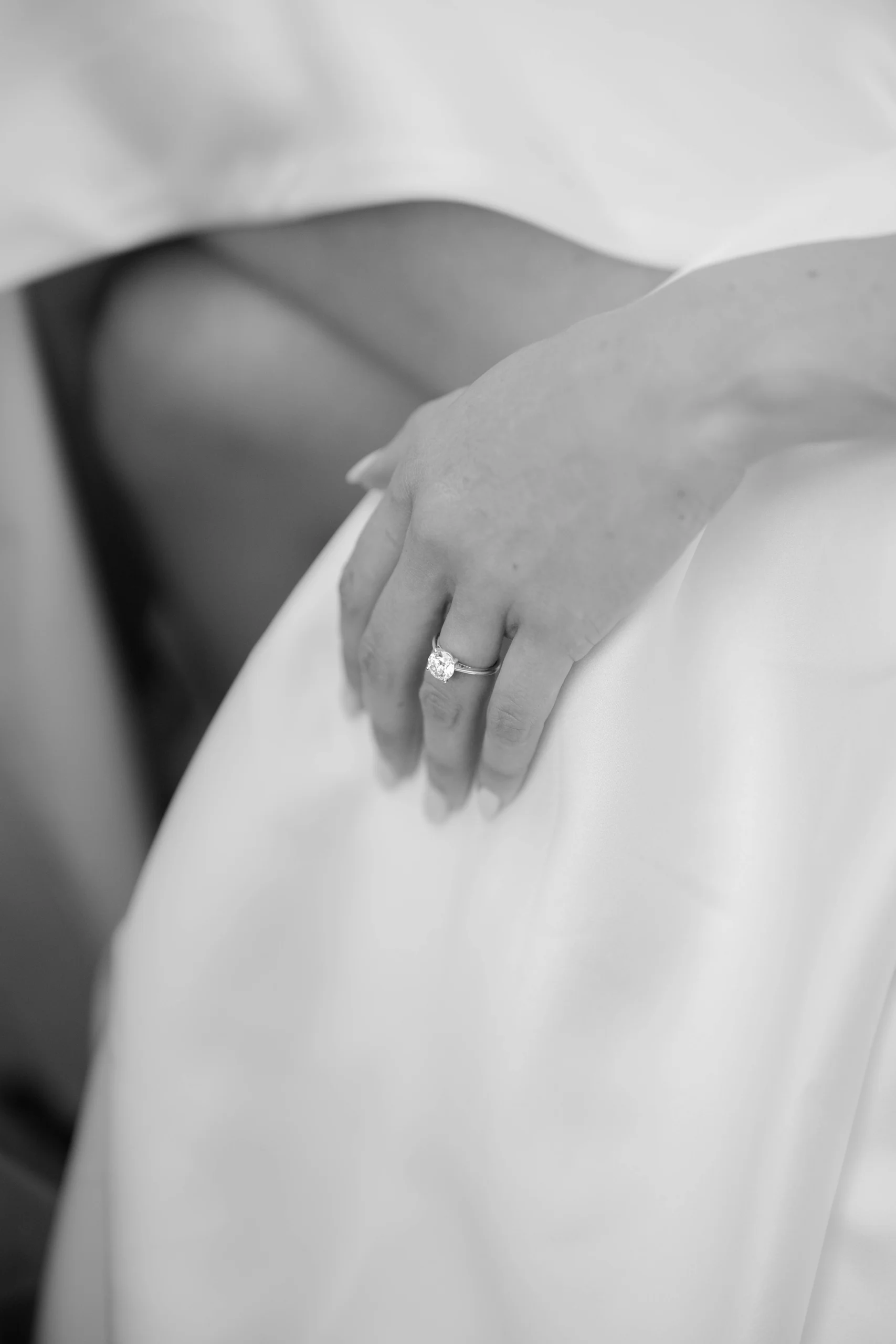 Close up of the bride’s hand with ring on the dress, black and white, Munich at La Villa