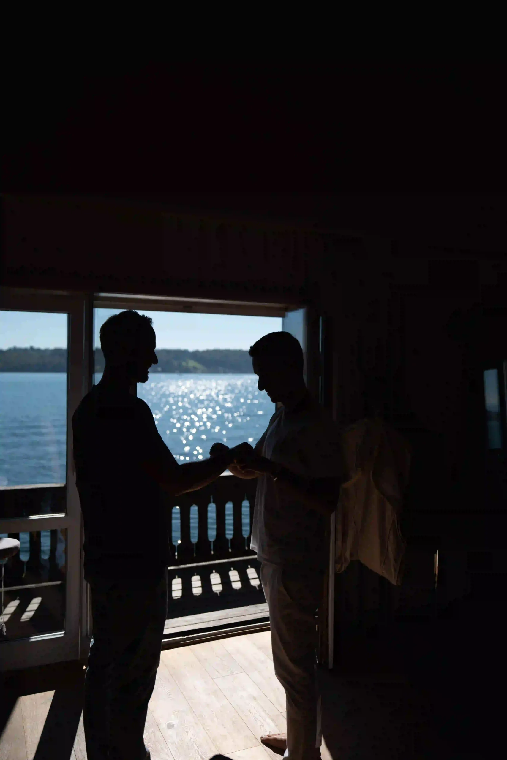 Bride and his mate  as silhouettes at sunset by the water, Munich wedding at La Villa
