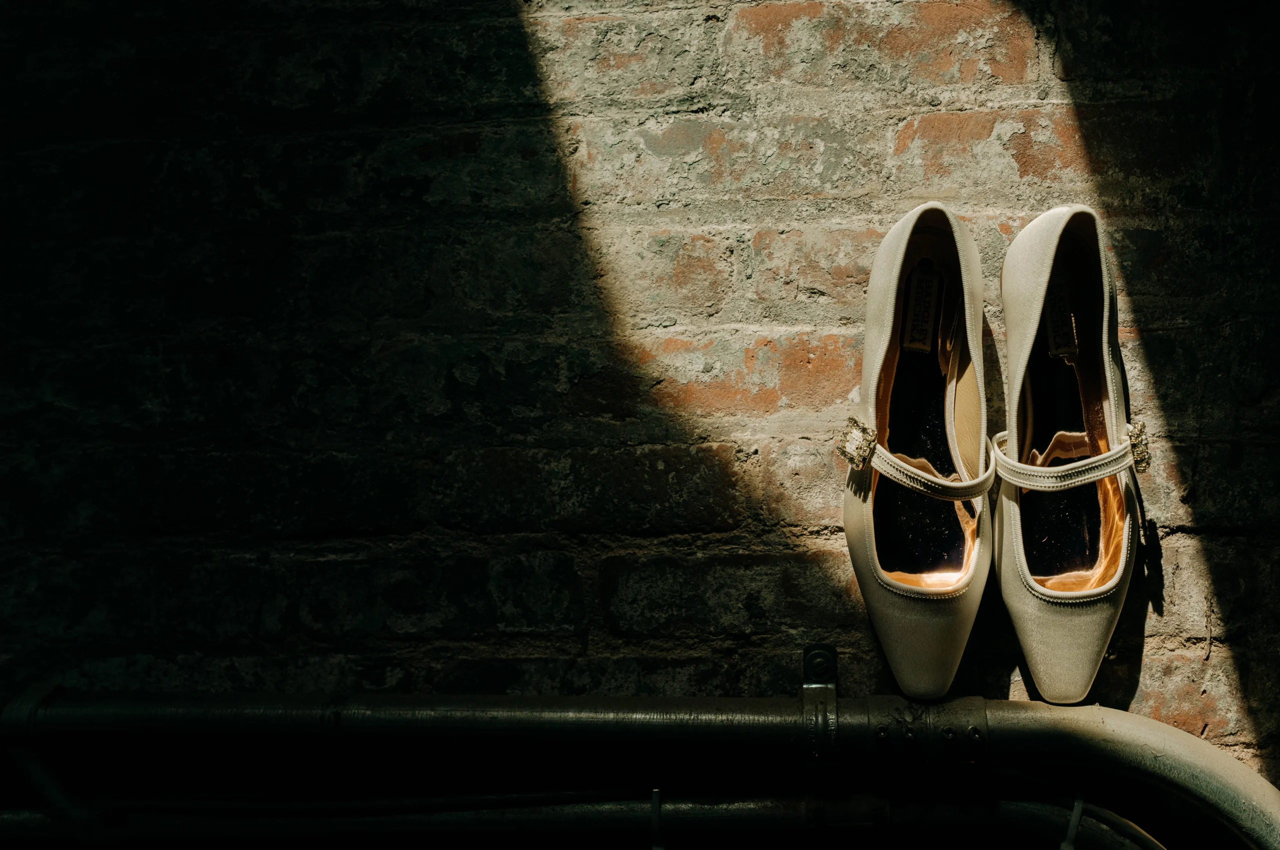 Bridal shoes on a brick wall at The Foundry NYC.