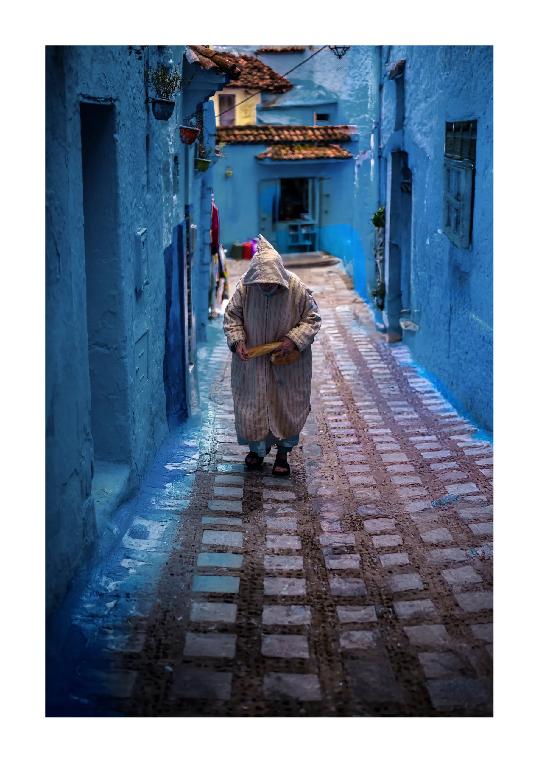 Chefchaouen fine art print of a person walking through a blue Moroccan alley