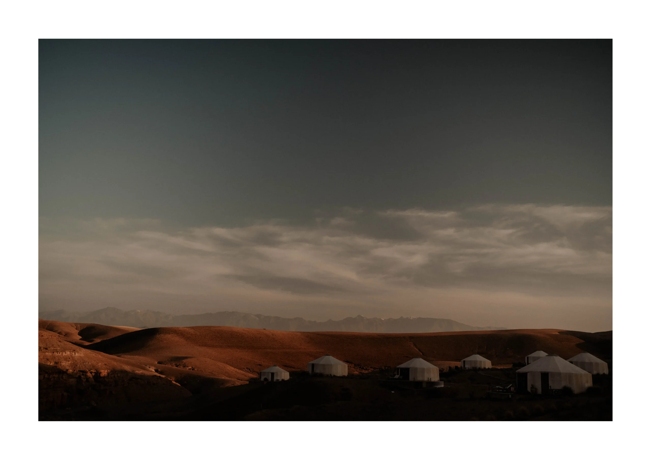 Marrakech desert fine art print of luxury tents under dramatic evening clouds